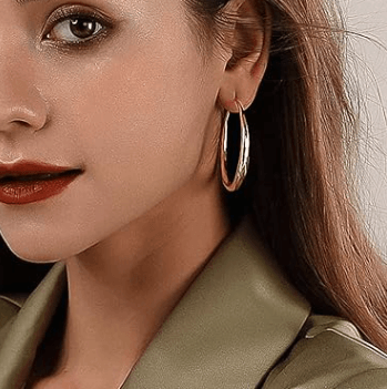 Woman wearing elegant earrings, showcasing stylish designs from the Hey Pretty You earrings collection.
