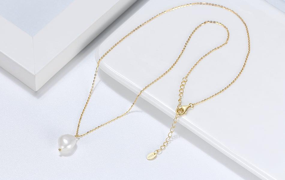 freshwater pearl in silver pendant, gold color. 45 degree angle