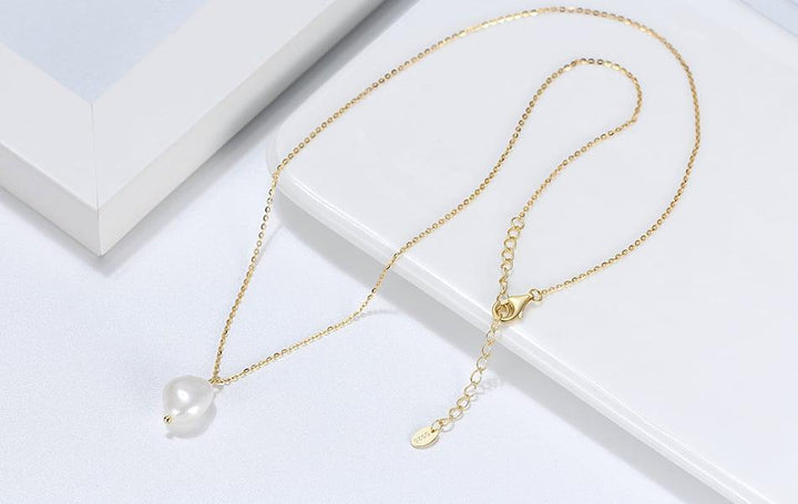 freshwater pearl in silver pendant, gold color. 45 degree angle
