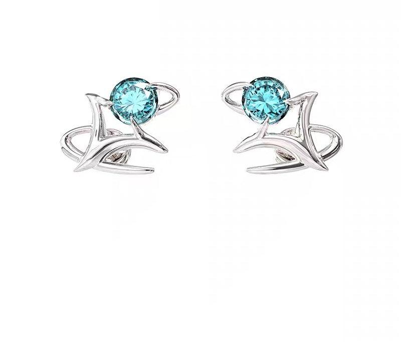 Elegant silver stud earrings featuring sparkling blue gemstones in a modern, abstract design.