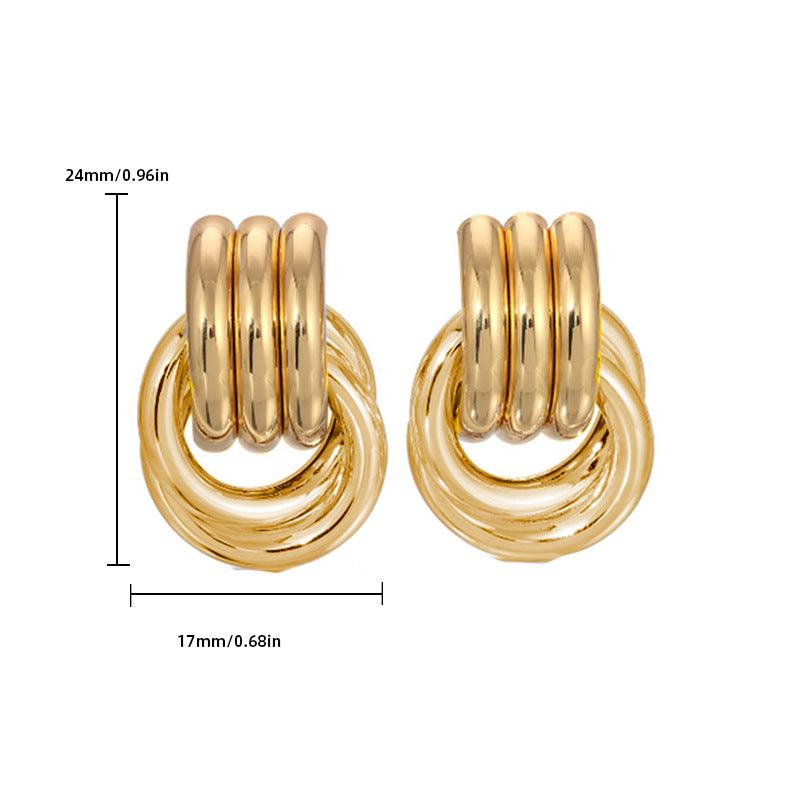 pair of gold-tone interlocking hoop earrings with measurements displayed: 24mm (0.96in) in height and 17mm (0.68in) in width, showcasing a stacked and polished design.