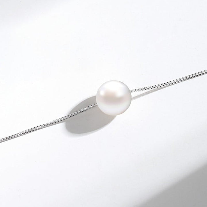 Simple and elegant pearl pendant necklace with a delicate silver chain, straight angle