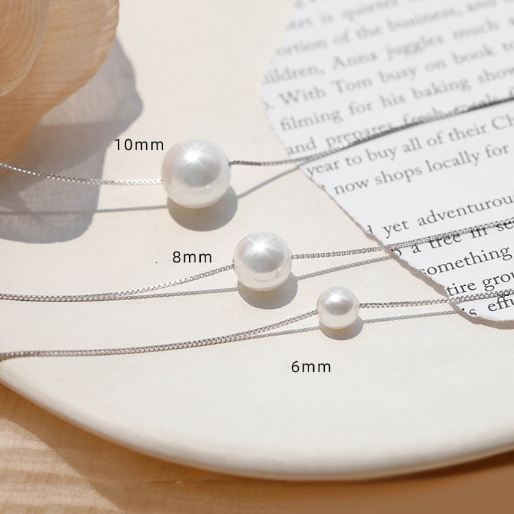 Simple and elegant pearl pendant necklace with a delicate silver chain, three different sizes