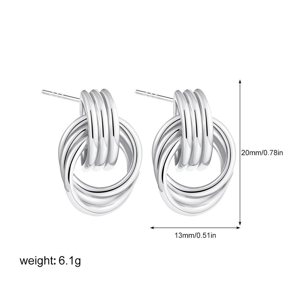 A pair of silver-tone interlocking hoop earrings with measurements displayed: 20mm (0.78in) in height and 13mm (0.51in) in width, weighing 6.1g, featuring a polished and stacked design.